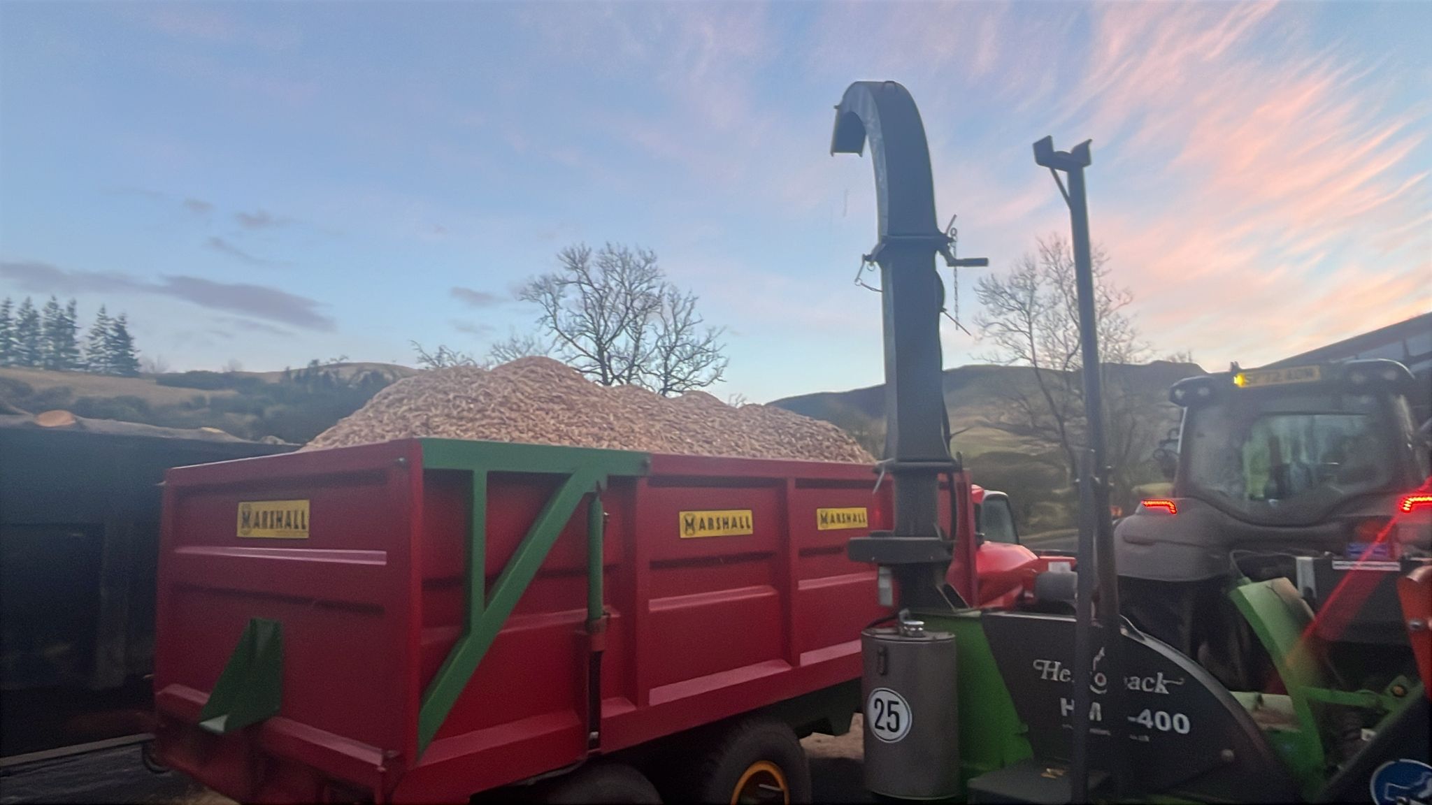 A trailer piled high with recycled wood chip mulch.